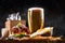 Set of hamburger beer and french fries. A standard set of drinks and food in the pub, beer and snacks. Dark background
