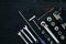 Set of hand bunch of tools in the garage on black wooden background