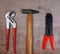 Set Hand Tools with Hammer, pincers, screwdriver, on wooden background