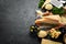 Set of hard cheeses with cheese knives on black stone background. Parmesan. Top view.