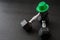 Set of hex head dumbbells with a green glitter leprechaun hat on a black gym floor, happy St. Patrick’s Day