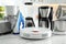 Set of home appliances in kitchen, focus on robotic vacuum cleaner