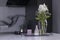 Set of home decoration - candle, vase and flowers - on a handmade black metal tray at the kitchen. home interior concept