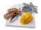 A set of house building bricks and trowel, with a yellow hard hat, electrical cables and pipes on a set of building plans,