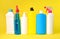 Set of household chemicals bottles on a yellow background