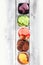 Set of ice cream scoops of different colors and flavours with berries, chocolate and fruits