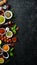 Set of Indian fragrant spices and herbs on a black stone background.