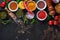 Set of Indian fragrant spices and herbs on a black stone background. Turmeric, dill, paprika, cinnamon, saffron, basil and