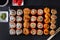 Set of Japanese rolls Philadelphia with salmon, California with caviar, baked with cheese and eel, wasabi, pickled ginger, soy