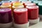 Set of jars of multicolored paint as background