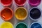 Set of jars of multicolored paint as background