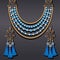 set of jewelry made of gold earrings and a necklace with precious stones and tassels