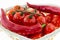 Set of juicy vegetables red tomatoes on a branch long pods of bright vegetables appetizing hot sauce ingredients on a white