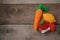 Set of knitted toys lemon, carrot, apple, amanita on wooden background. Earlier tactile development of children, craft toys