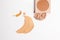 Set of liquid face powder and concealer brush strokes in different colour in texture, drop of skin tint serum , bronzing powder
