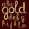 A set of lowercase Latin letters made of thick golden cream.