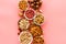 Set of macadamia, hazelnut, walnut, almond, pistachio, pecans nuts on pink background top-down pattern copy space