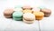 Set of macarons on white wooden table