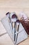 A set of makeup brushes of various shapes lies on the makeup artist's table with a cover of their artificial leather