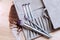 A set of makeup brushes of various shapes lies on the makeup artist's table next to an eagle feather as a decoration