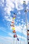 Set of Marine signal flags on a mast against of cloudy sky.