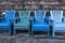 Set of matching blue chairs on a beachfront property patio on a clear day