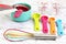 Set of measuring cups, measuring spoons, measuring glasses and silicone whisk use in cooking lay on marble tabletop