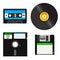 Set of media of different generations - vinyl record, cassette tape, a 3.5-inch floppy disk on a 5.25-inch diskette.