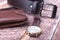 Set of men`s accessories for the business with leather belt, wallet, watch and smoking pipe on a wooden background. The