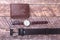 Set of men`s accessories for the business with leather belt, wallet, watch and smoking pipe on a wooden background. The