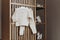 Set of merino wool organic baby clothes with hanger on bed. Present for cold weather. Newborn gifts for Christmas and