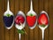 Set of metal spoons with berries.