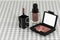 Set of NARS Radiant Creamy Concealer cosmetics. Makeup tools on table cloths background