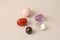 A set of natural stones lies on a light white background  garnet  amethyst  carnelian  rock crystal and rose quartz. Collection of