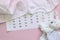 Set of newborn accessories in anticipation of  child - calendar with circled number 20 twenty, baby clothes, toys on pink