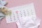 Set of newborn accessories in anticipation of  child - calendar with circled number 3 three baby clothes, toys on pink