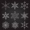 Set of nine vintage vector illustration christmas snowflakes on chalkboard background. flourish calligraphic handmade