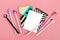 Set of notebooks for notes and pens on pink background Place for text Flat lay Top view Goals,Means, Resolution concept