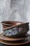 A set of old ceramic tableware. A set of plates, bowls. A branch of apricots. Dark wooden background