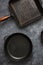 Set old grill pans dark stone background top view