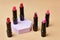 Set of open lipsticks on trendy pedestal, unbranded presentation of cosmetics