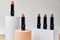Set of open lipsticks on trendy pedestals, unbranded presentation of cosmetics