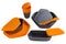 A set of orange plastic dishes for camping or for travel, food containers, plates and spoons, a plastic glass, on a white
