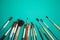 Set of paint brushes on the turquois background