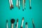 Set of paint brushes on the turquois background