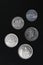 set of paraguayan coins in a row isolated on black background