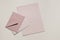 Set of pastel, blush pink blank envelopes and paper sheet mockups. Beige neutral background. Mailing, correspondence and