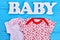 Set of patterned baby-girl clothing.