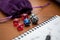 Set of pen, notebook, and dices to play role game like dungeons and dragons. Purple bag to storage the dices