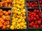 Set peppers orange yellow and red lying in boxes in supermark